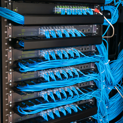 A network rack with neatly bundled blue patch cables